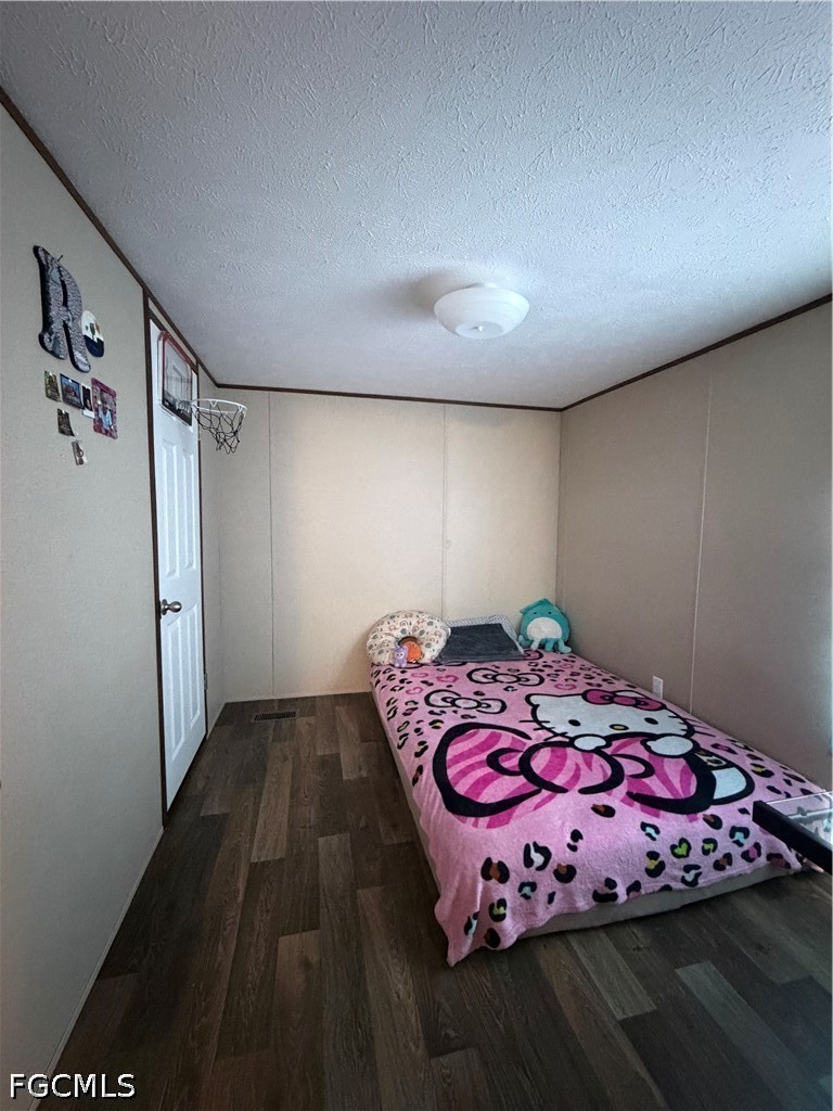 631 Stanton Street Clewiston, FL 33440 - Photo 15 of 24 a bedroom with a bed and a dresser