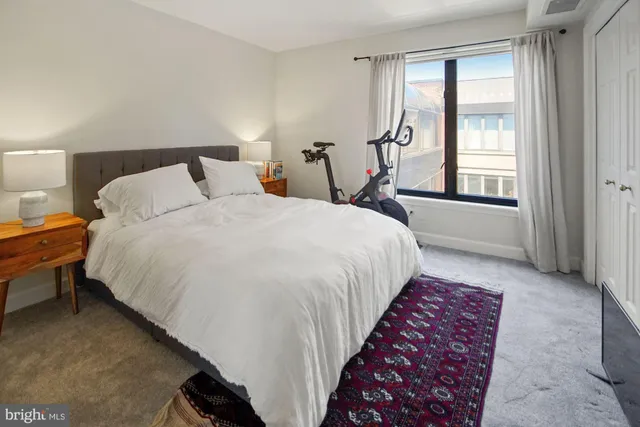 a bed room with a bed and a chair