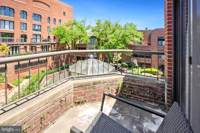 a city view from a balcony with outdoor seating