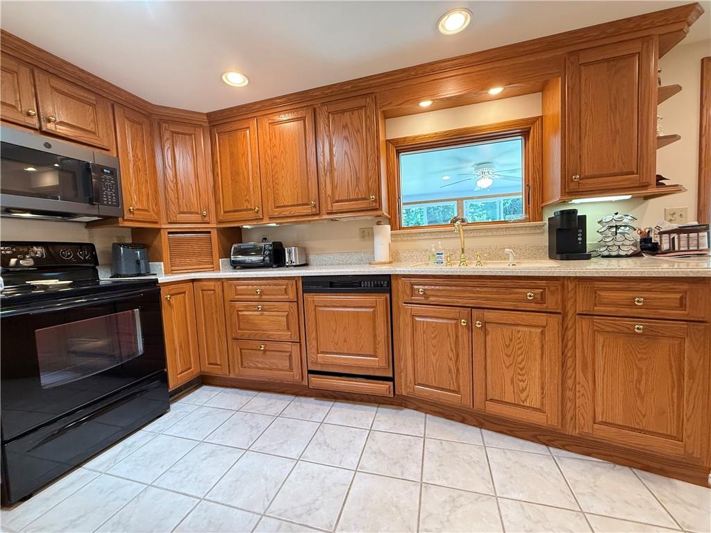 325 Williamson Road Greenville, PA 16125 - Photo 20 of 50 a kitchen with a stove a sink and a microwave