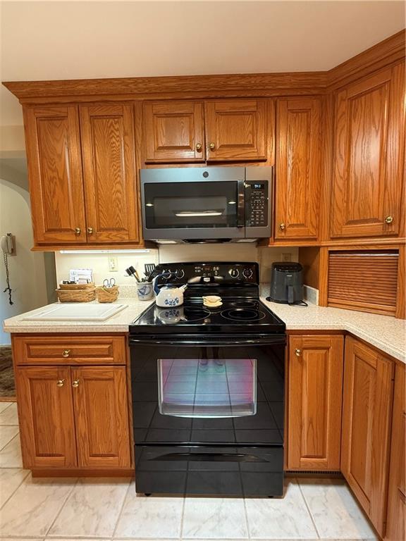 325 Williamson Road Greenville, PA 16125 - Photo 22 of 50 a kitchen with wooden cabinets and a stove top oven