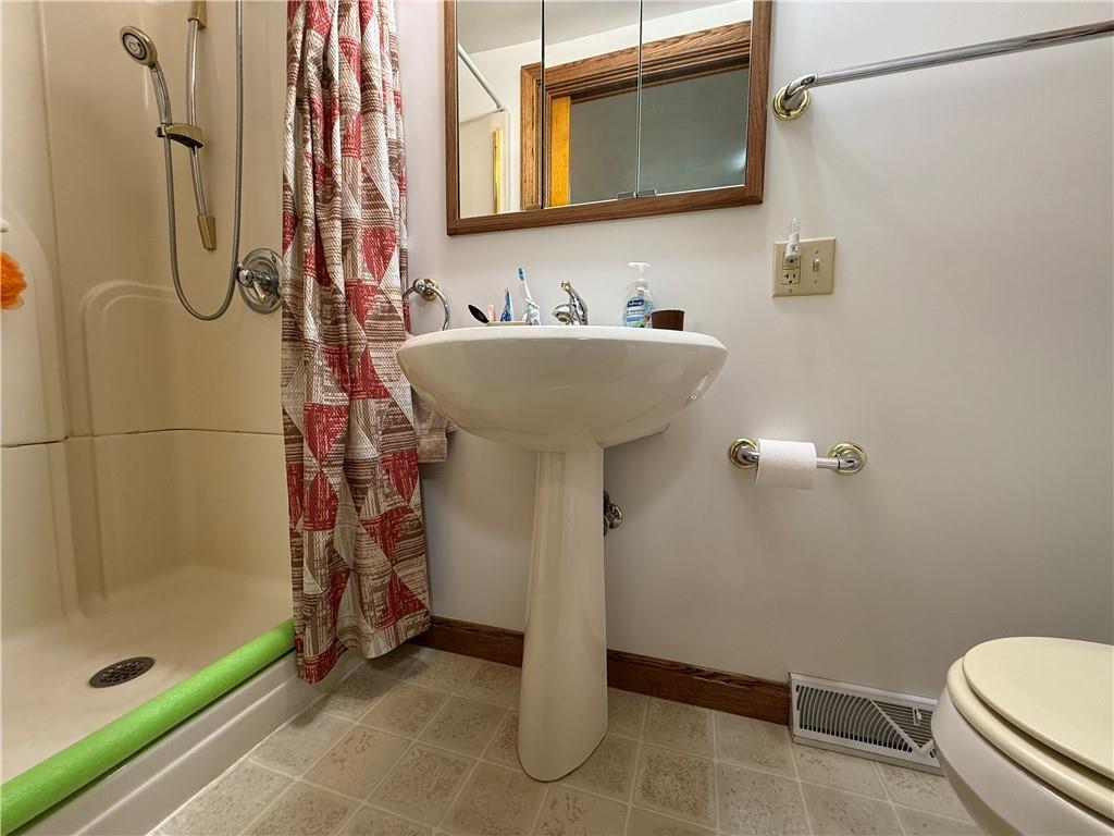 325 Williamson Road Greenville, PA 16125 - Photo 37 of 50 a bathroom with a sink a toilet and shower