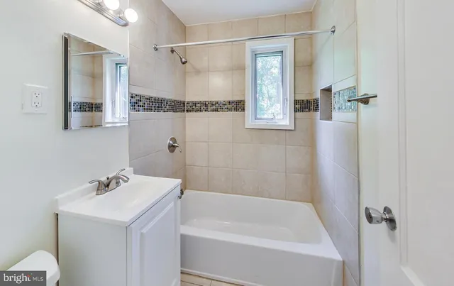 a bathroom with a bathtub a shower a sink and a mirror