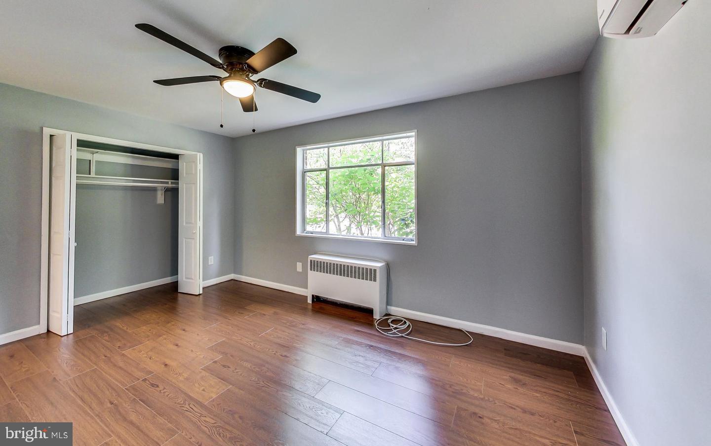10301 Montrose Avenue, Unit 101 Bethesda, MD 20814 - Photo 12 of 27 an empty room with wooden floor and windows