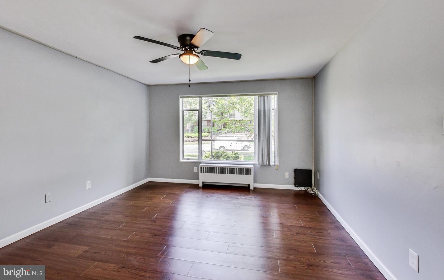 10301 Montrose Avenue, Unit 101 Bethesda, MD 20814 - Photo 15 of 27 a view of empty room with wooden floor and fan