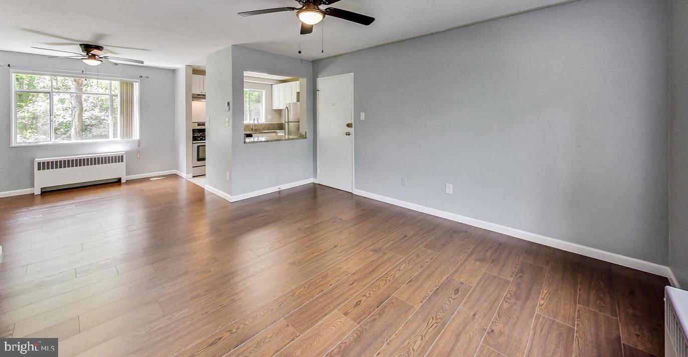 10301 Montrose Avenue, Unit 101 Bethesda, MD 20814 - Photo 16 of 27 wooden floor in an empty room with a window