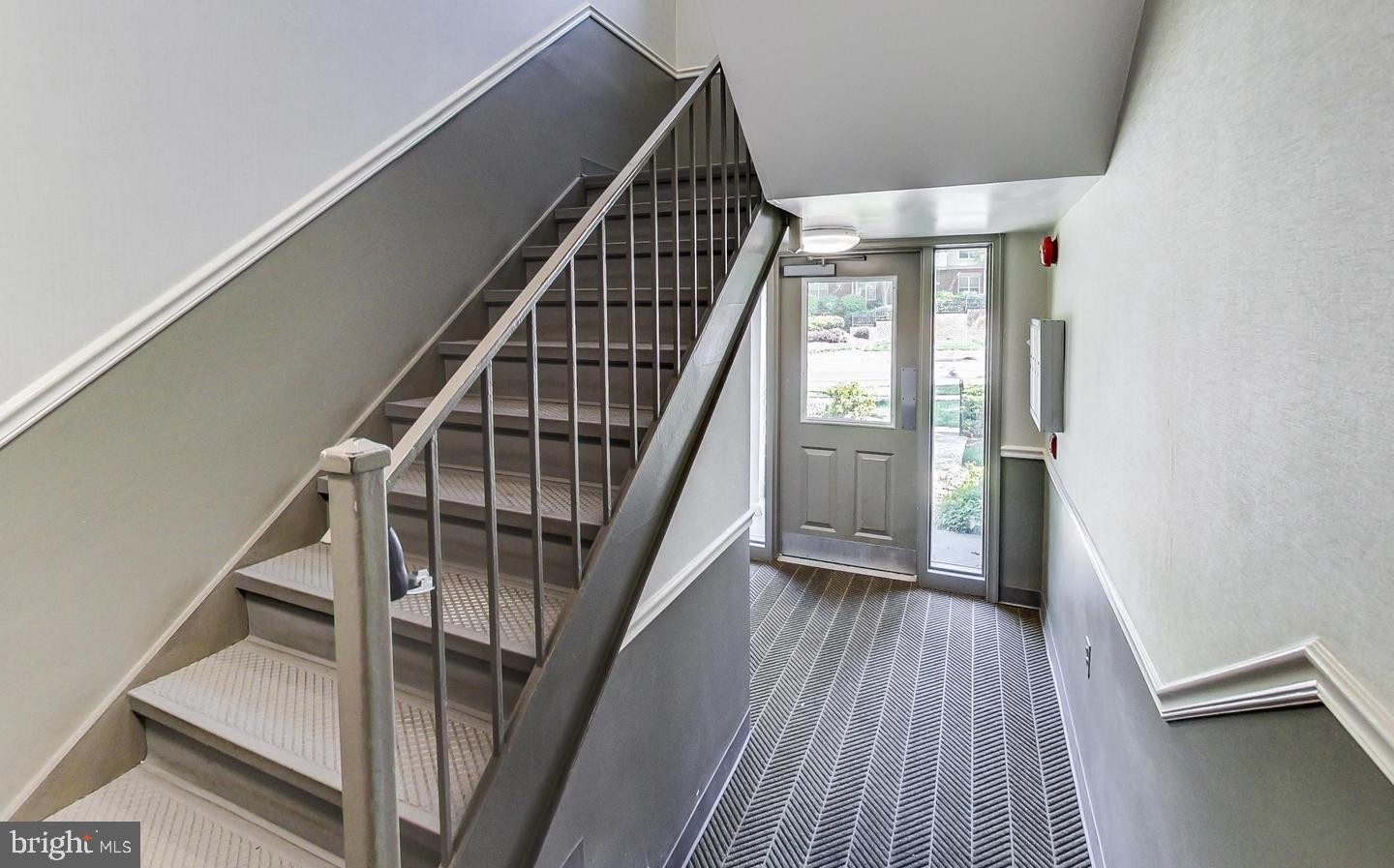 10301 Montrose Avenue, Unit 101 Bethesda, MD 20814 - Photo 19 of 27 a view of staircase with wooden floor and white walls