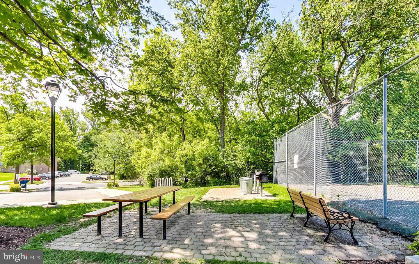 10301 Montrose Avenue, Unit 101 Bethesda, MD 20814 - Photo 23 of 27 a swimming pool with outdoor seating and yard