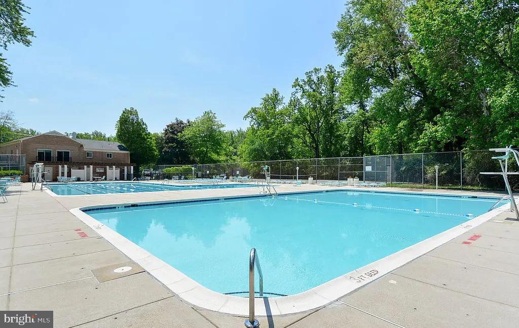 10301 Montrose Avenue, Unit 101 Bethesda, MD 20814 - Photo 24 of 27 a view of a swimming pool with a lounge chair