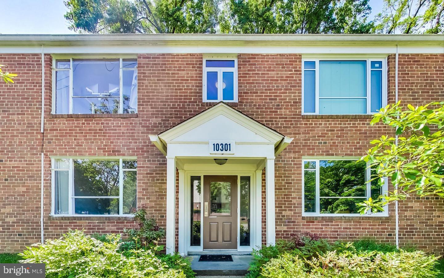 10301 Montrose Avenue, Unit 101 Bethesda, MD 20814 - Photo 26 of 27 a front view of a house with garden