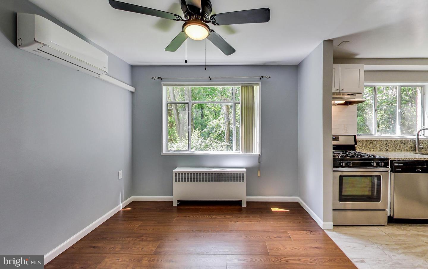 10301 Montrose Avenue, Unit 101 Bethesda, MD 20814 - Photo 5 of 27 a view of an empty room with a window and wooden floor