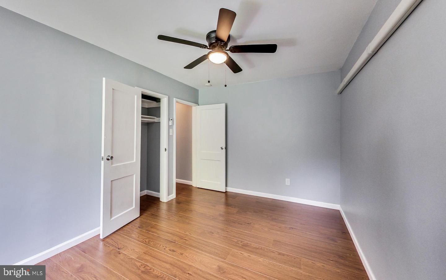 10301 Montrose Avenue, Unit 101 Bethesda, MD 20814 - Photo 9 of 27 a view of empty room with wooden floor and ceiling fan