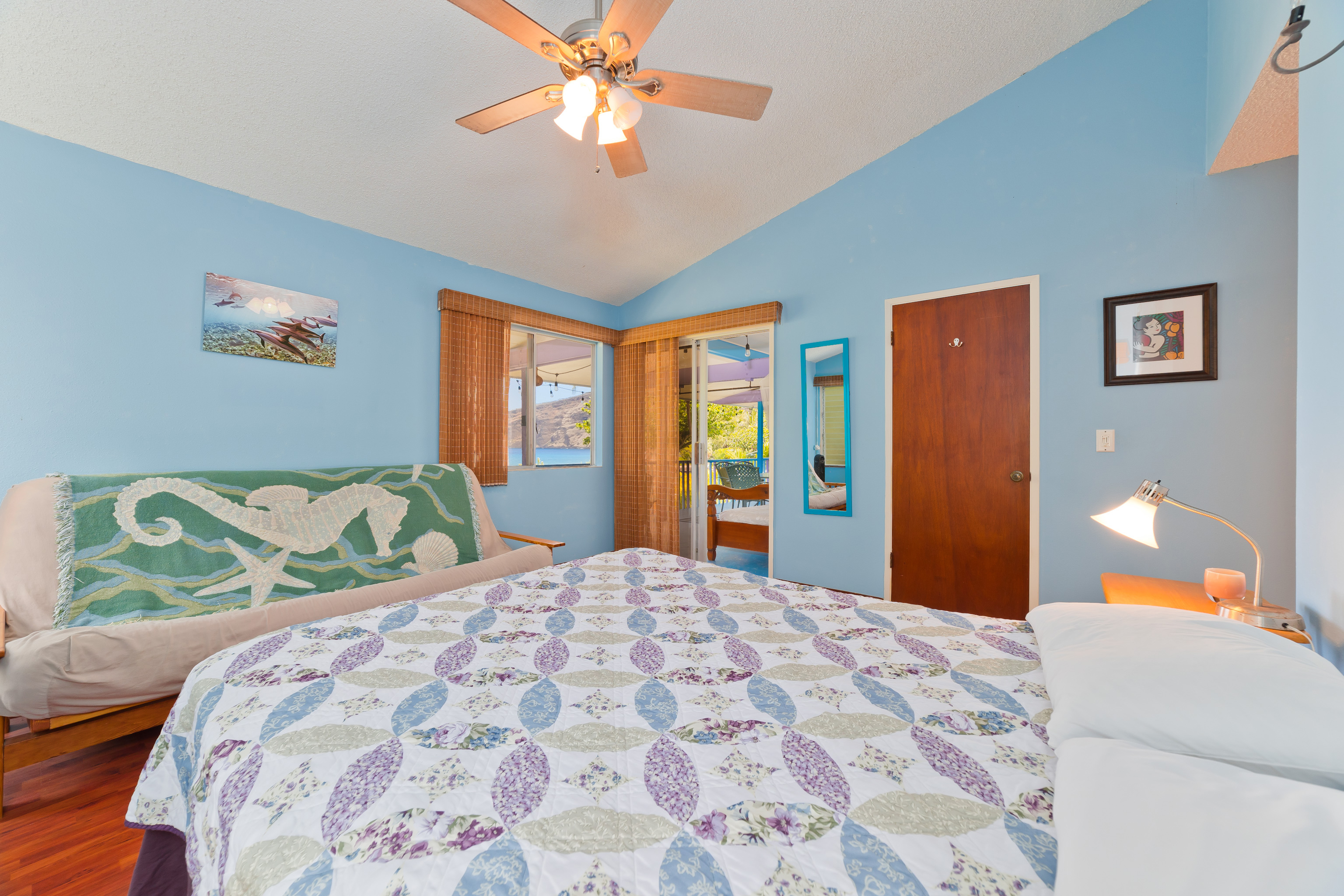 82-6301 Puuhonua Road Captain Cook, HI 96704 - Photo 14 of 27 a bedroom with a bed and a chandelier