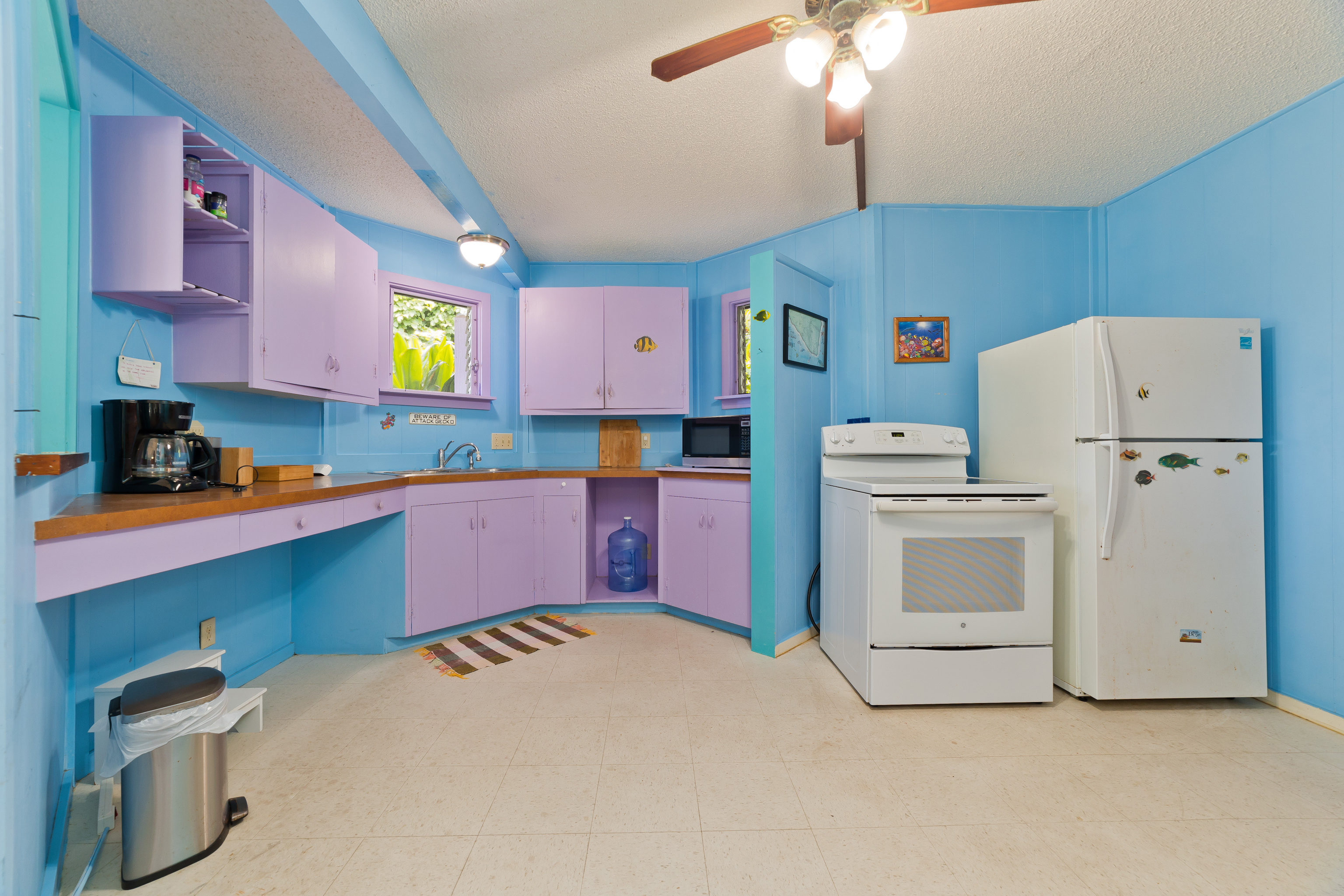 82-6301 Puuhonua Road Captain Cook, HI 96704 - Photo 21 of 27 a kitchen with cabinets and white appliances