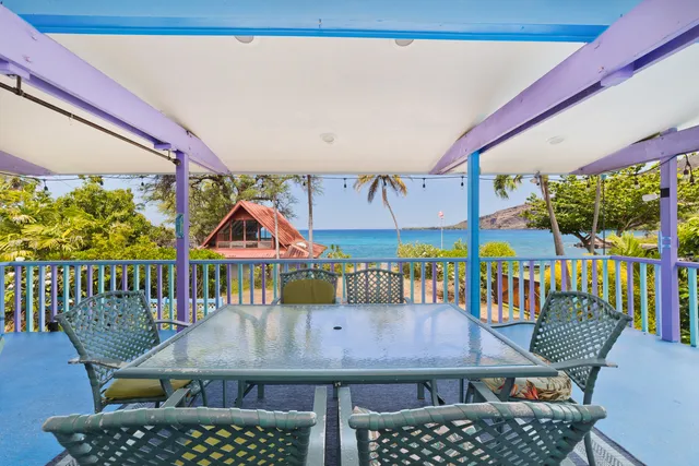 a view of a patio with a table and chairs