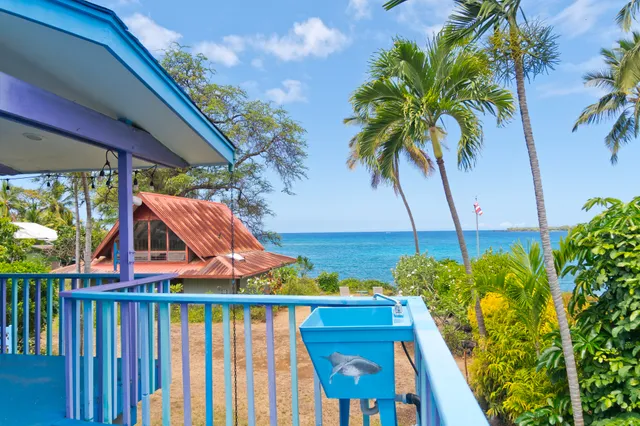 a view of yard from deck with patio