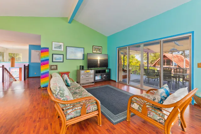 a view of a dining room with furniture a chandelier and wooden floor