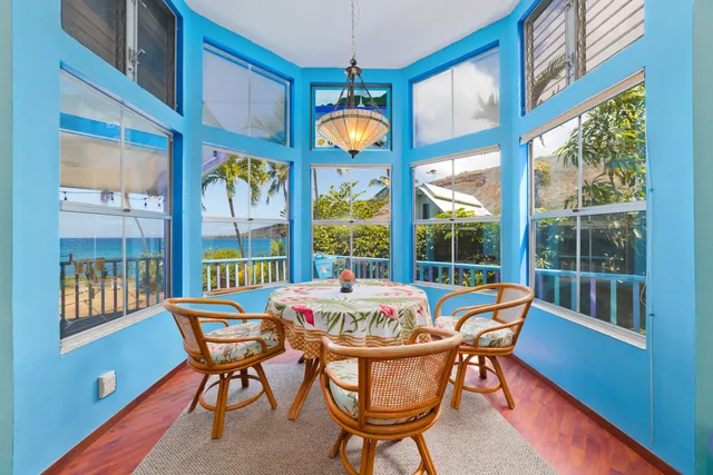 a view of a dining room with furniture a chandelier and a large window