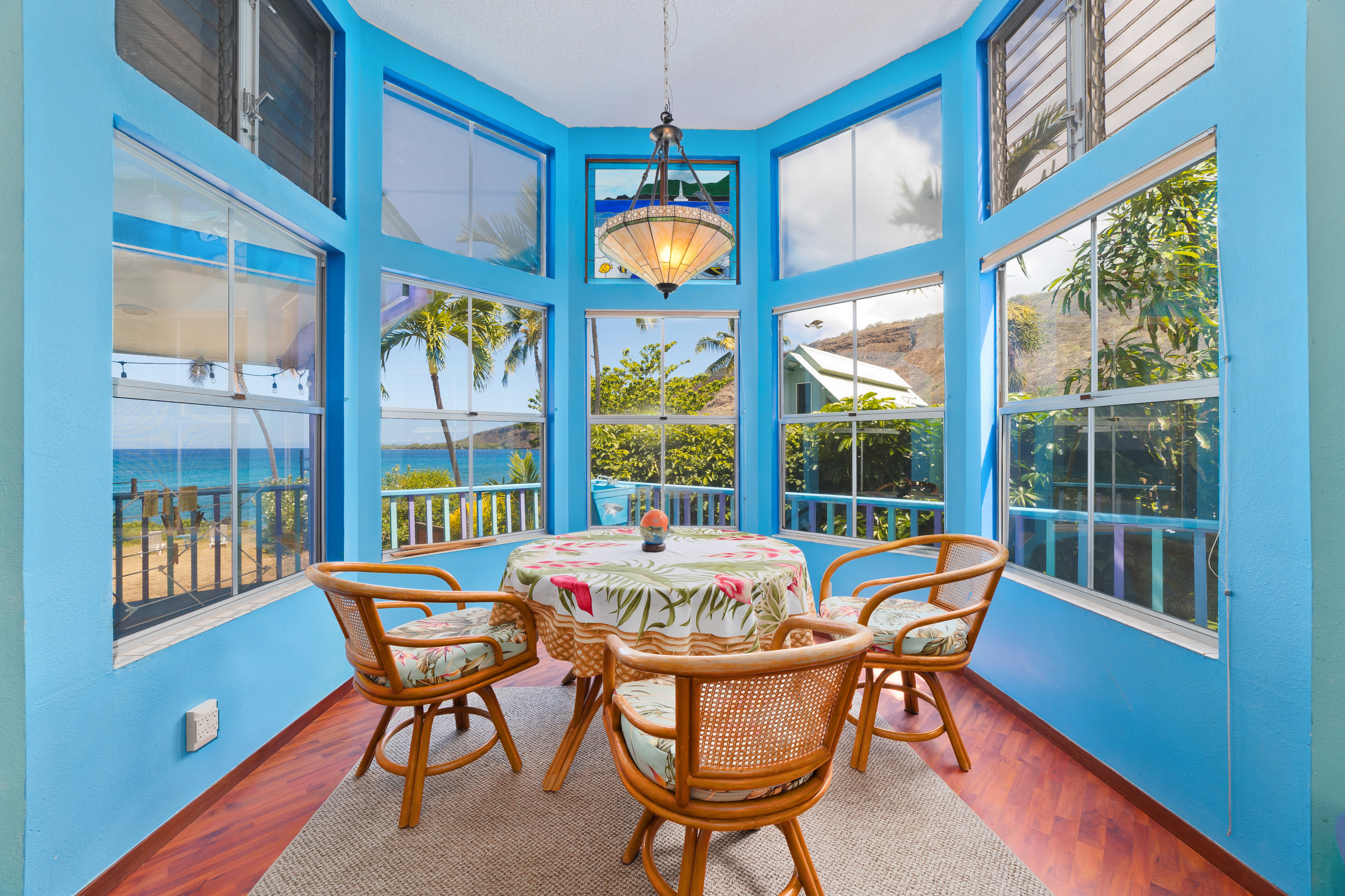 82-6301 Puuhonua Road Captain Cook, HI 96704 - Photo 10 of 27 a view of a dining room with furniture a chandelier and wooden floor