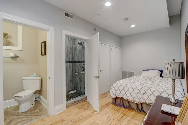 a bedroom with a bed and a toilet