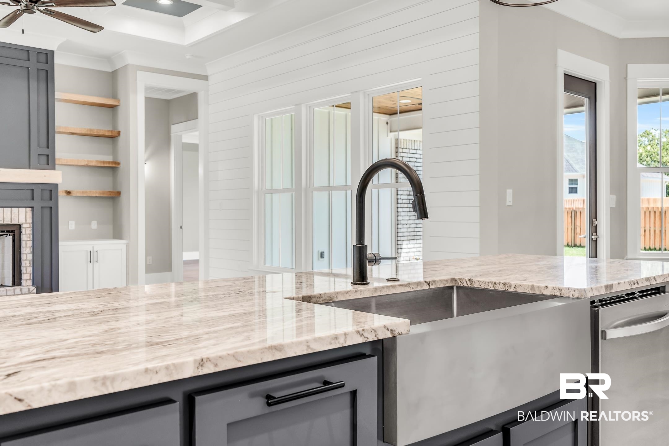 17786 Burwick Loop Fairhope, AL 36532 - Photo 53 of 57 Kitchen with stainless steel dishwasher, crown molding, ceiling fan, and light stone counters