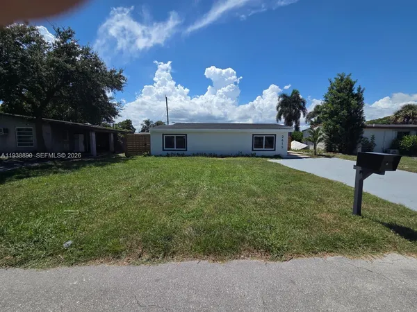 a view of a house with a yard and a garden