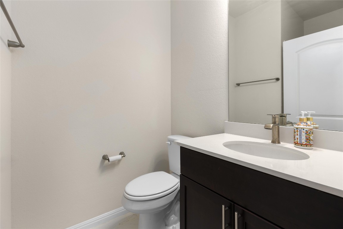 5513 Durango Pass Austin, TX 78724 - Photo 14 of 31 a bathroom with a sink and a toilet