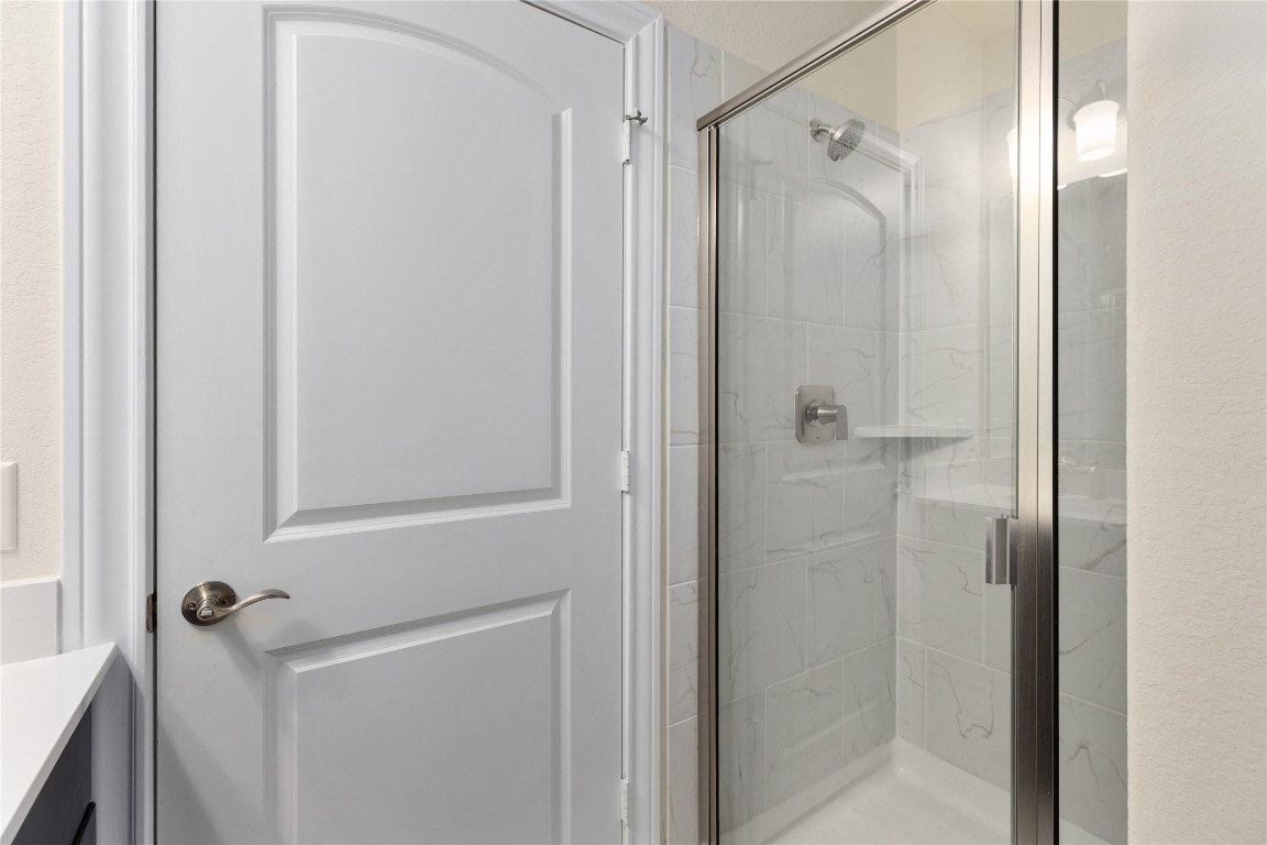 5513 Durango Pass Austin, TX 78724 - Photo 15 of 31 a bathroom with a shower and a glass door