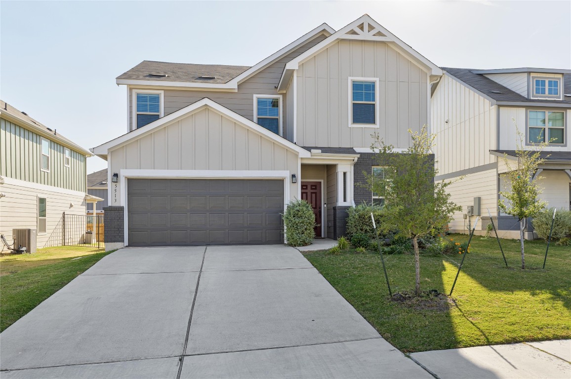5513 Durango Pass Austin, TX 78724 - Photo 2 of 31 a front view of a house with a yard and potted plants