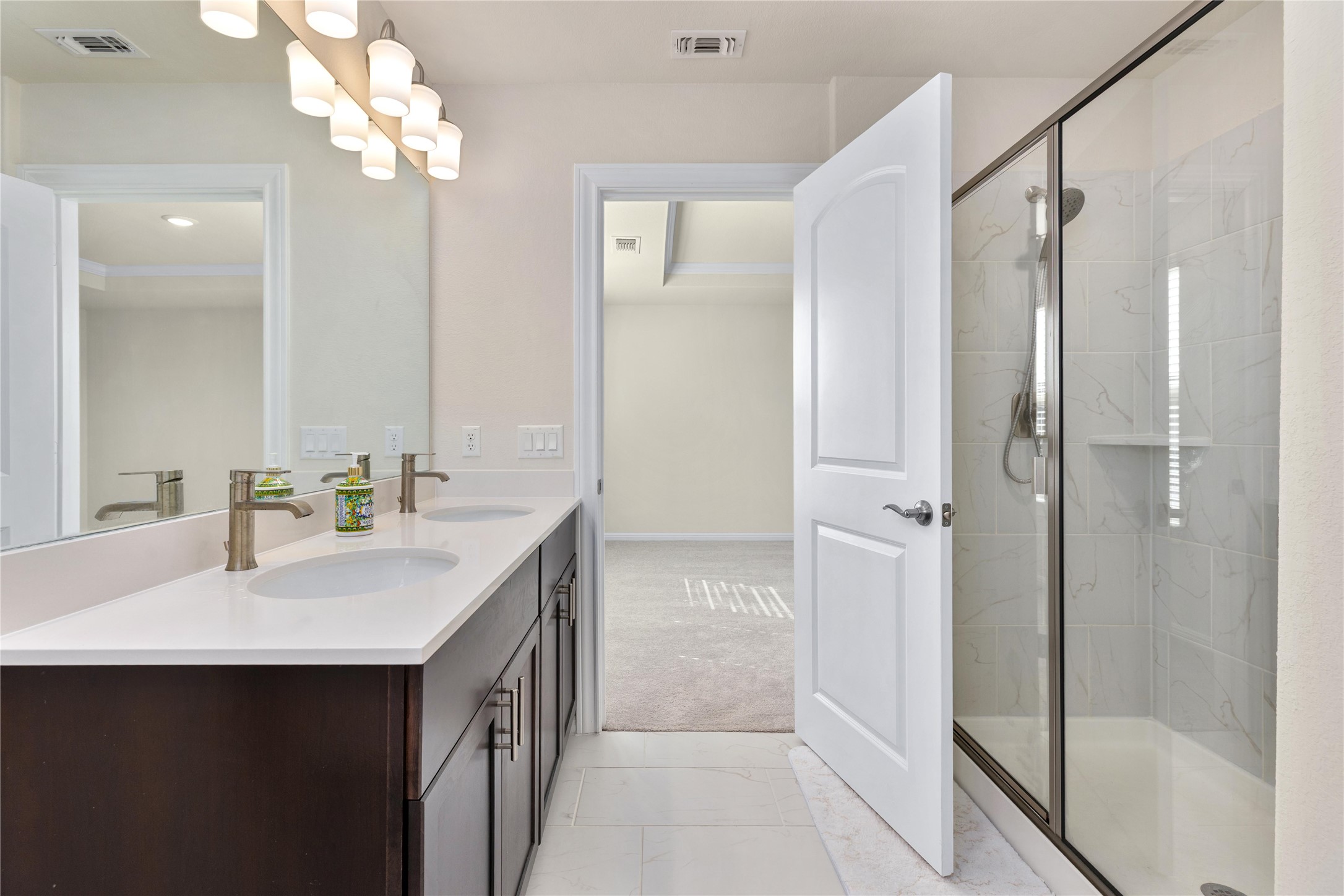 5513 Durango Pass Austin, TX 78724 - Photo 21 of 31 a bathroom with a double vanity sink mirror and shower