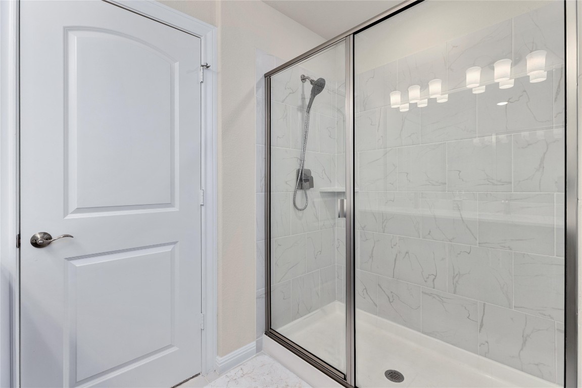 5513 Durango Pass Austin, TX 78724 - Photo 22 of 31 a bathroom with a glass shower door
