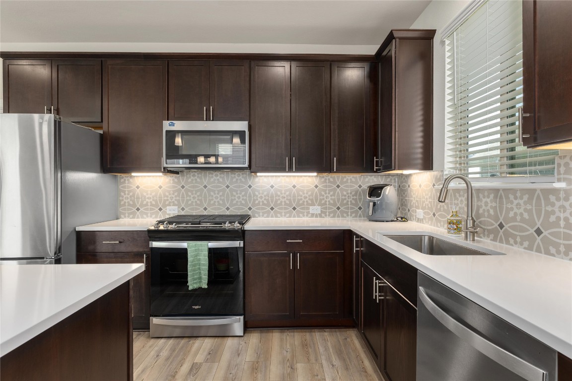 5513 Durango Pass Austin, TX 78724 - Photo 10 of 31 a kitchen with a sink stove and refrigerator