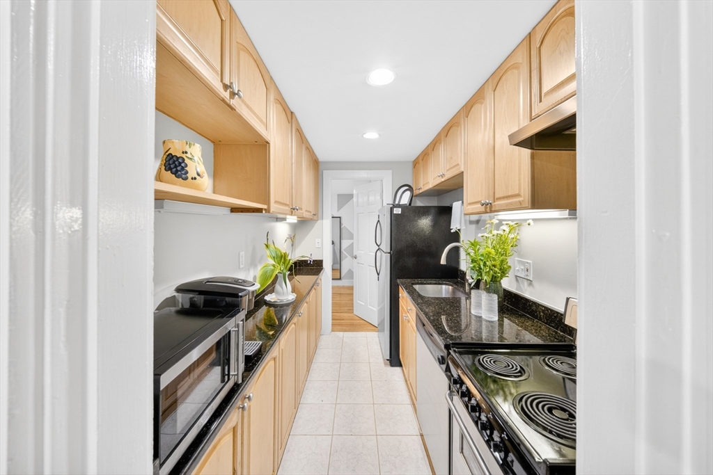 352 Tappan Street, Unit 1 Brookline, MA 02445 - Photo 18 of 42 a kitchen with stainless steel appliances a stove a sink and a refrigerator