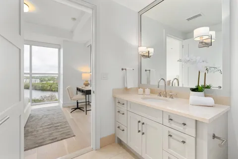 a bathroom with a sink toilet and a mirror