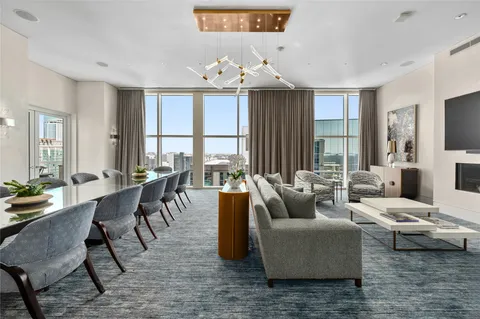 a living room with furniture and kitchen view