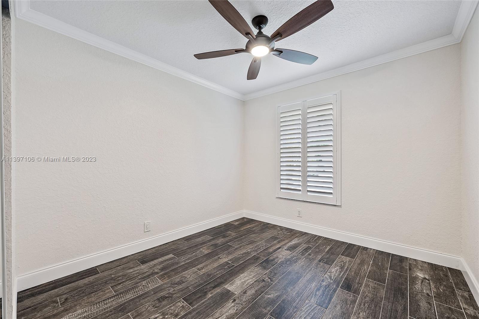 169 Greentree Circle Jupiter, FL 33458 - Photo 14 of 38 an empty room with a window and a ceiling fan
