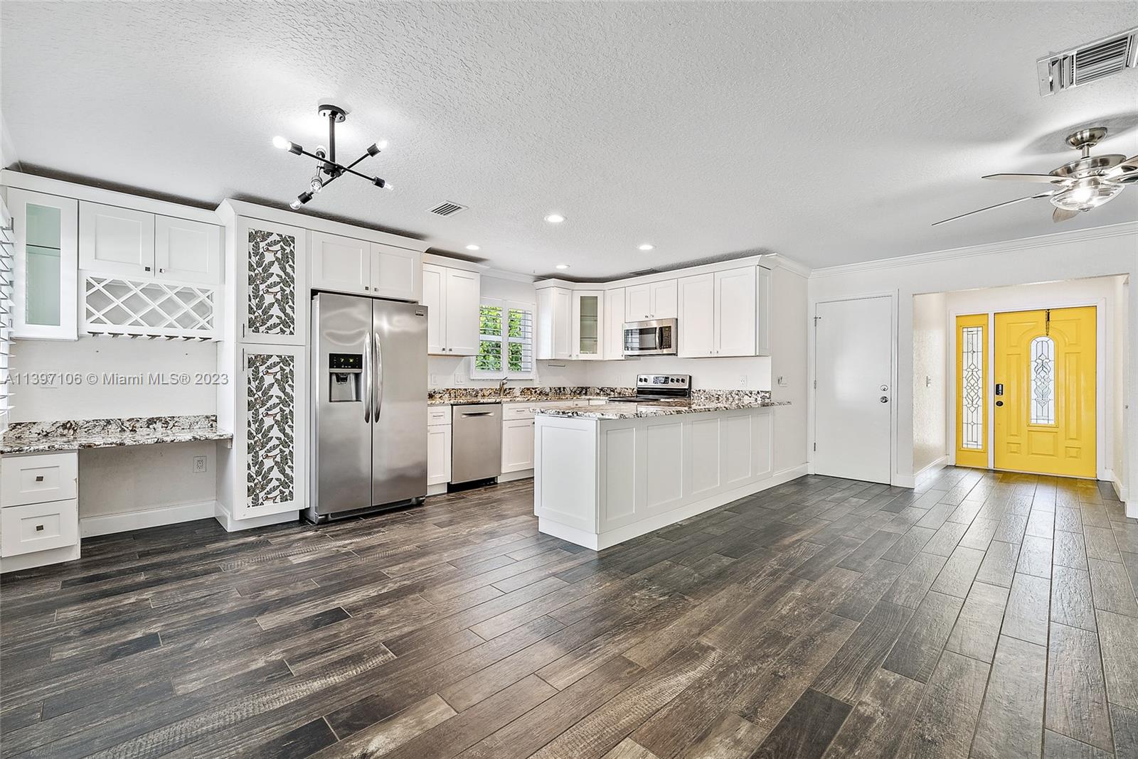 169 Greentree Circle Jupiter, FL 33458 - Photo 3 of 38 a view of a kitchen with wooden floor and electronic appliances