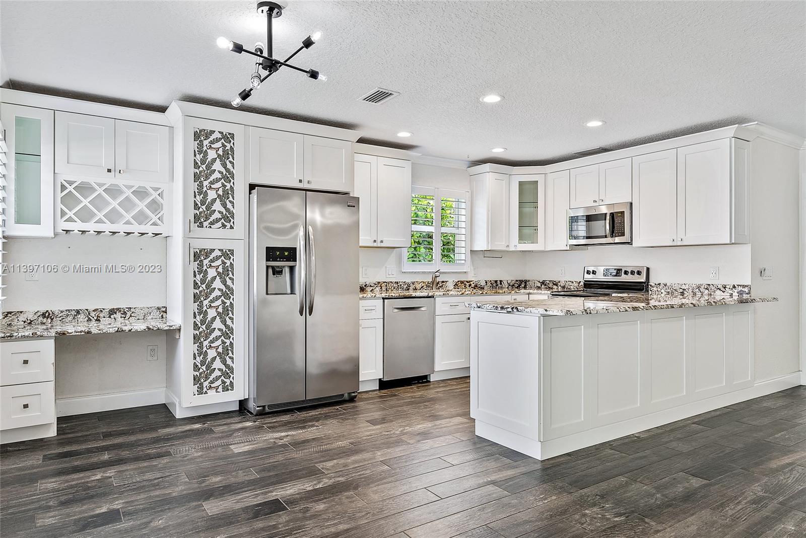 169 Greentree Circle Jupiter, FL 33458 - Photo 6 of 38 a kitchen with stainless steel appliances granite countertop a refrigerator and a stove top oven