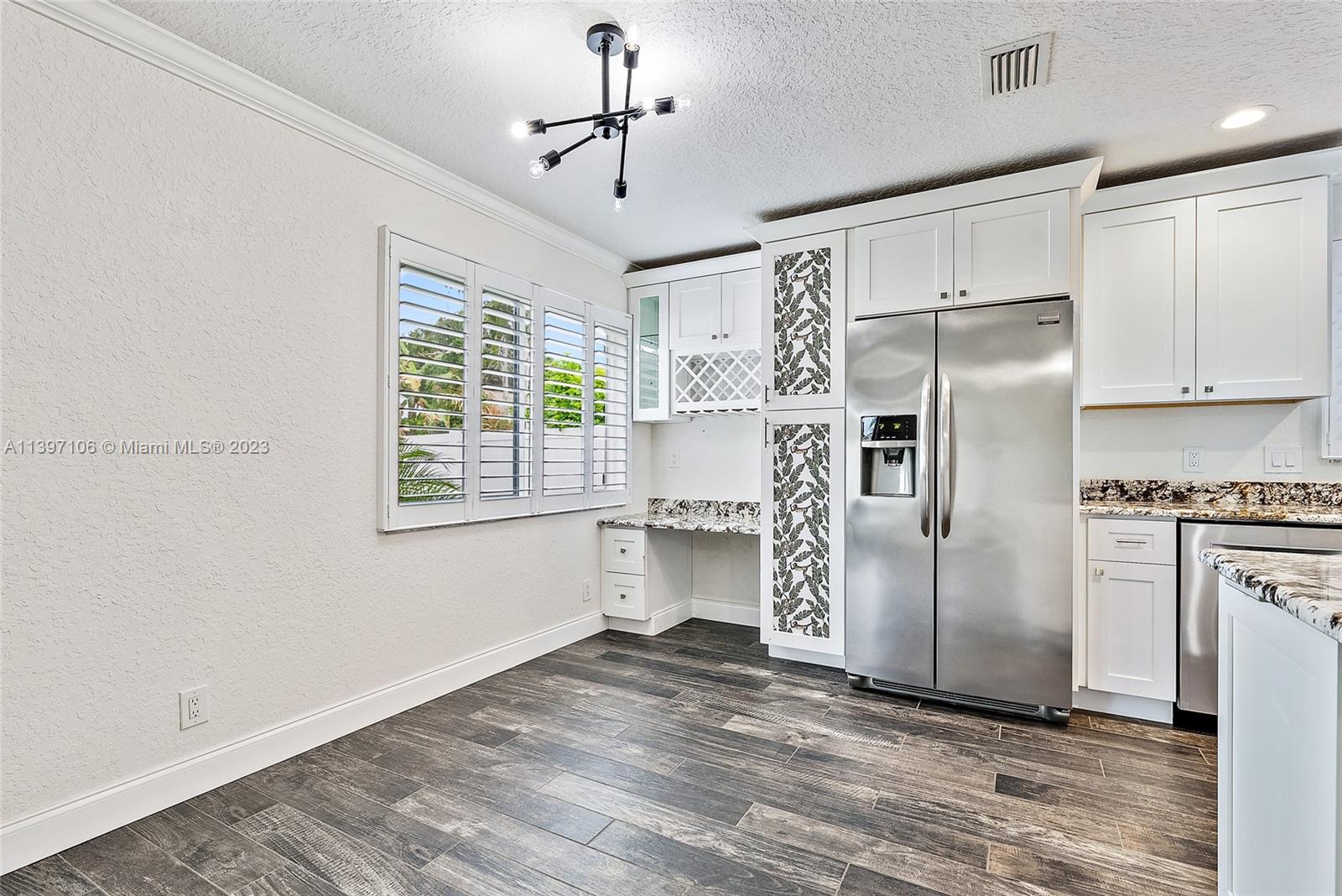 169 Greentree Circle Jupiter, FL 33458 - Photo 7 of 38 a kitchen with stainless steel appliances a refrigerator and a stove top oven