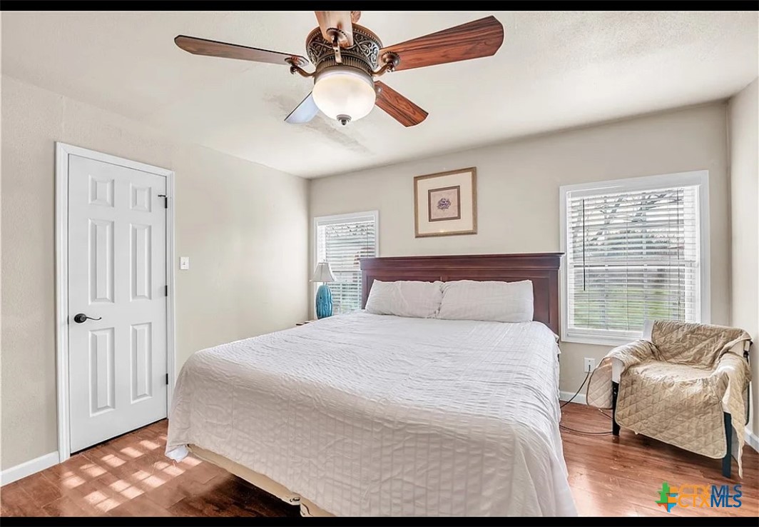 1017 South 6th Street Temple, TX 76504 - Photo 6 of 13 a bedroom with a bed and a couch