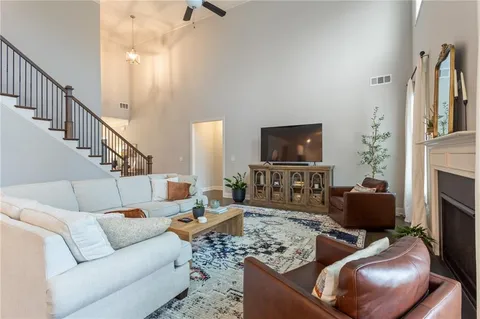 a living room with furniture wooden floor and a rug