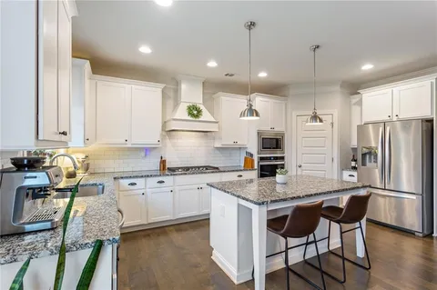 a kitchen with a stove a sink and a refrigerator