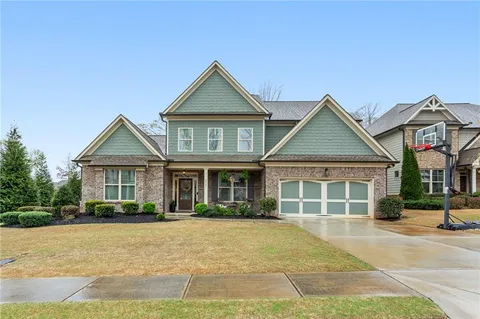 a front view of a house with a yard and garage