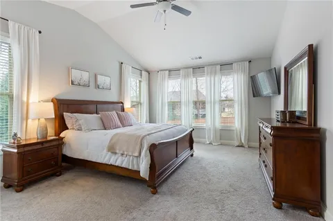 a bedroom with a bed and a mirror on dresser