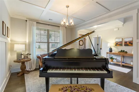 a living room with furniture and a piano
