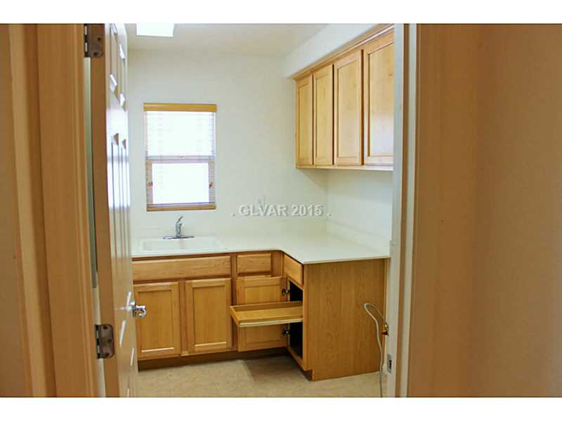 7914 Red Rock Ridge Avenue Las Vegas, NV 89179 - Photo 15 of 35 Property Photo. Large upstairs laundry room with upgraded cabinets and laundry sink.