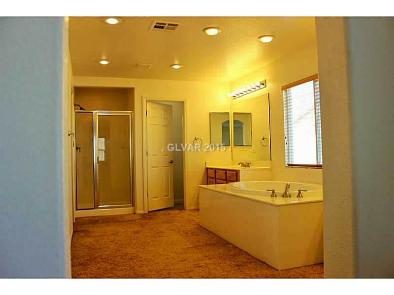 7914 Red Rock Ridge Avenue Las Vegas, NV 89179 - Photo 18 of 35 Property Photo. Master Bathroom with dual sinks and separate shower.