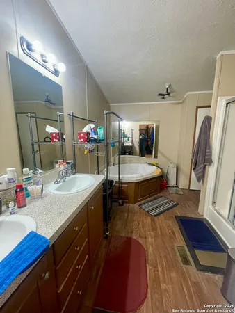 a bathroom with a shower and a sink