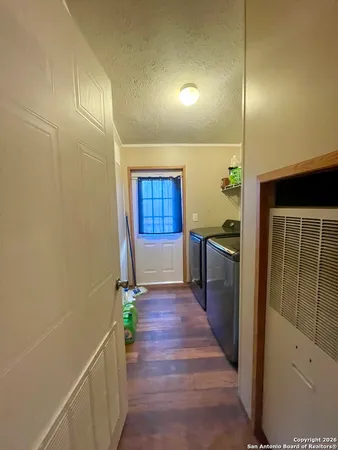 a kitchen with a sink and wooden floor