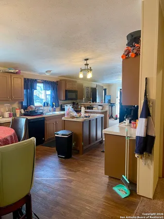a living room with furniture and a kitchen view